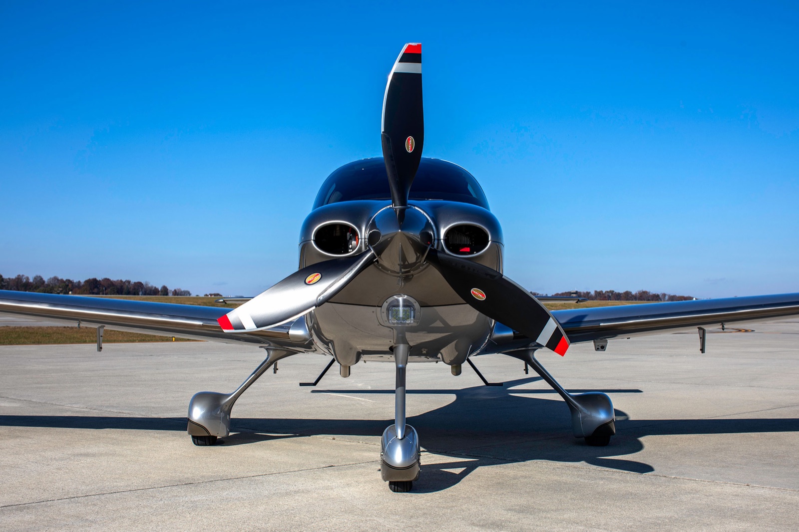Cirrus SR22 head-on on the ramp, three-blade propeller and cowling in frame